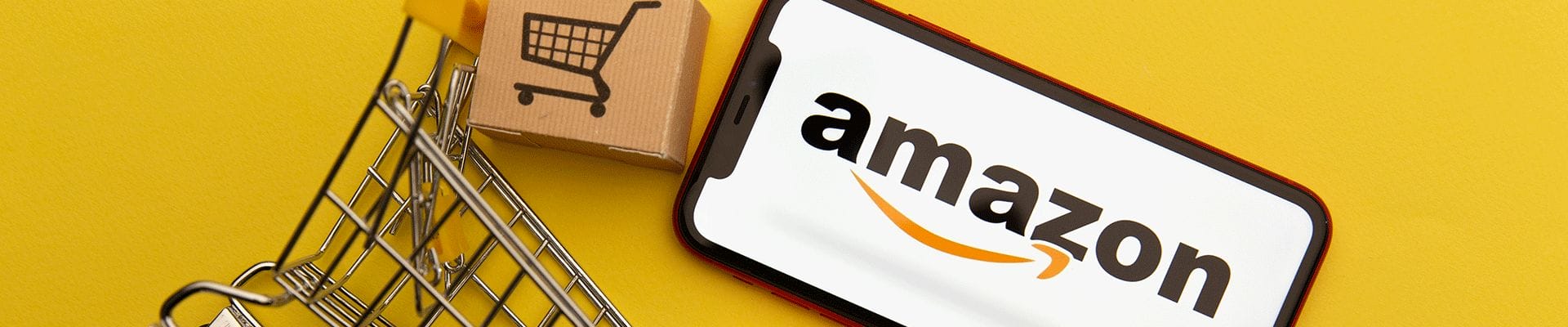 yellow background with amazon phone and mini shopping cart