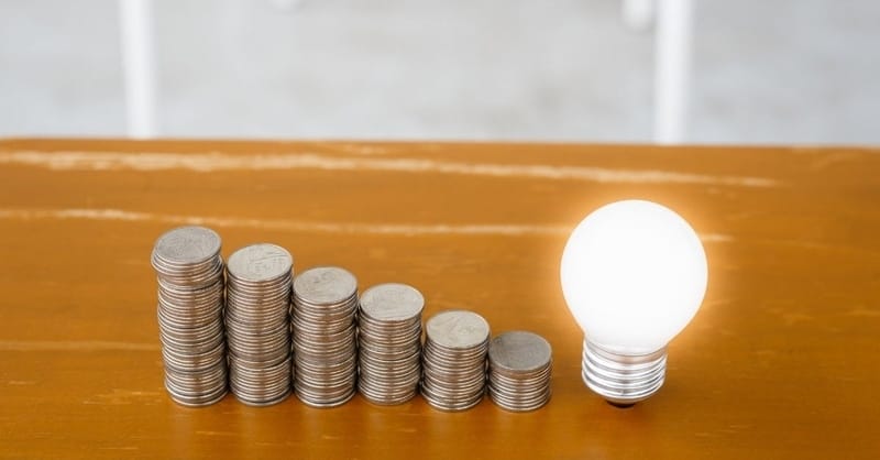 6 stacks of quarters with a lightbulb